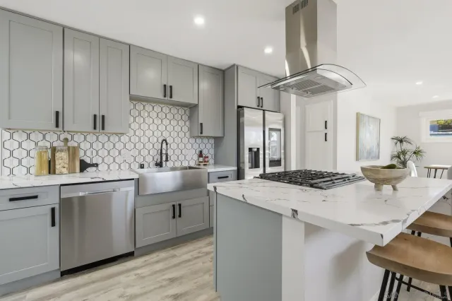 a kitchen with a sink a stove a refrigerator and cabinets