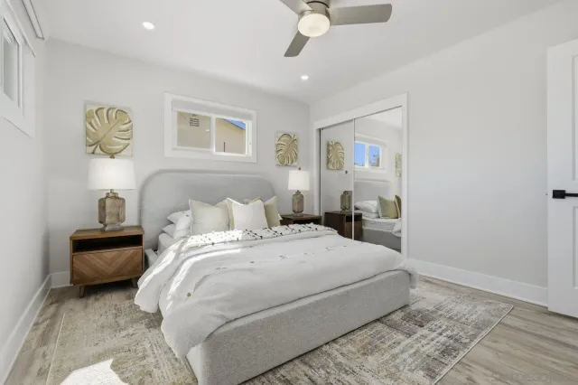 a bed room with a bed and a painting