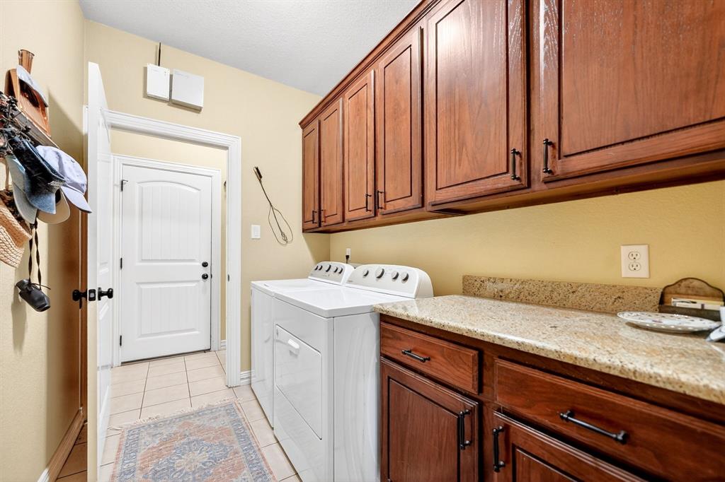 1399 Canyon Lake Road Wills Point, TX 75169 - Photo 27 of 37 a utility room with granite countertop a sink a washer and dryer