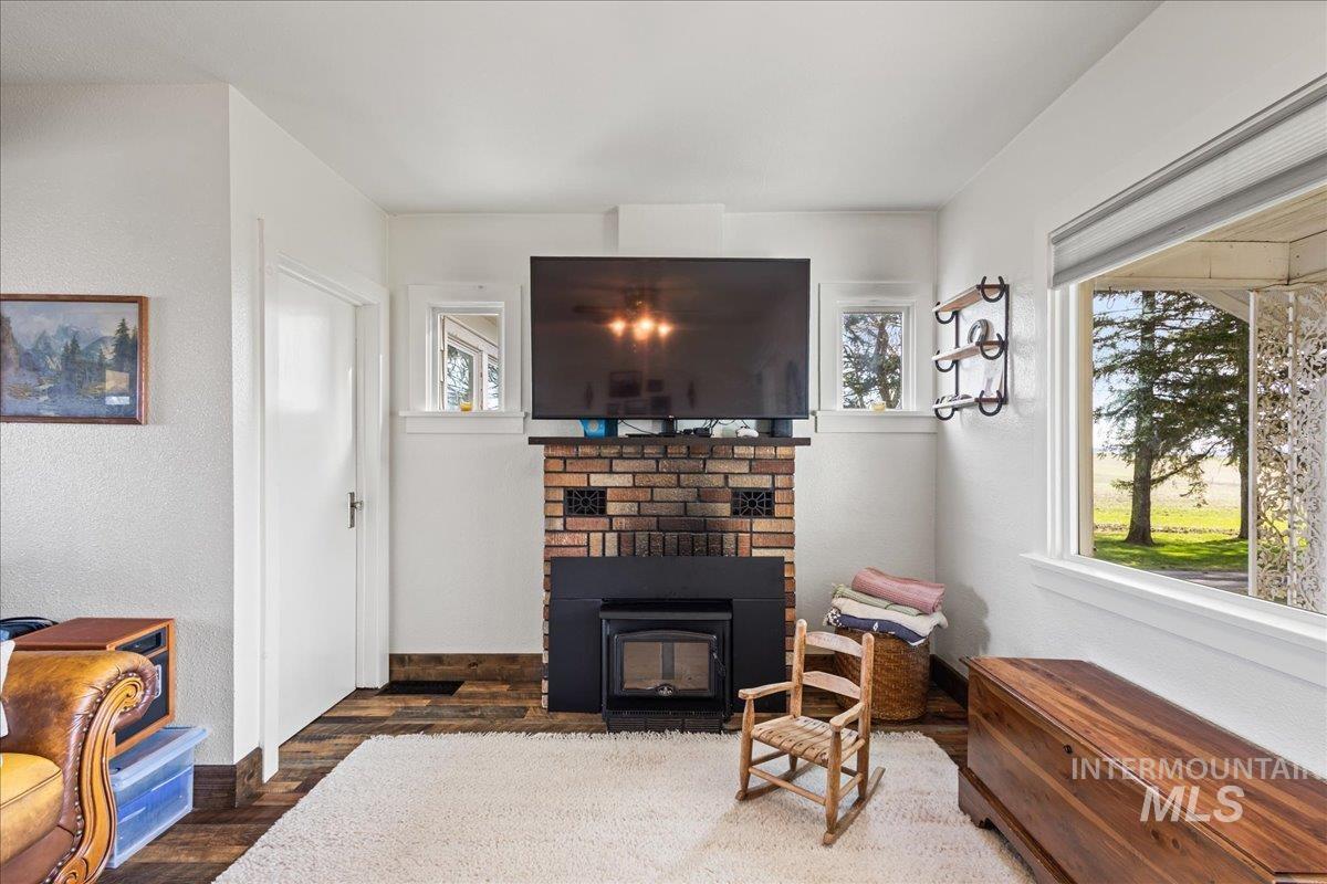 19454 Idaho Road Worley, ID 83876 - Photo 17 of 39 Brick fireplace with a wood-burning insert
