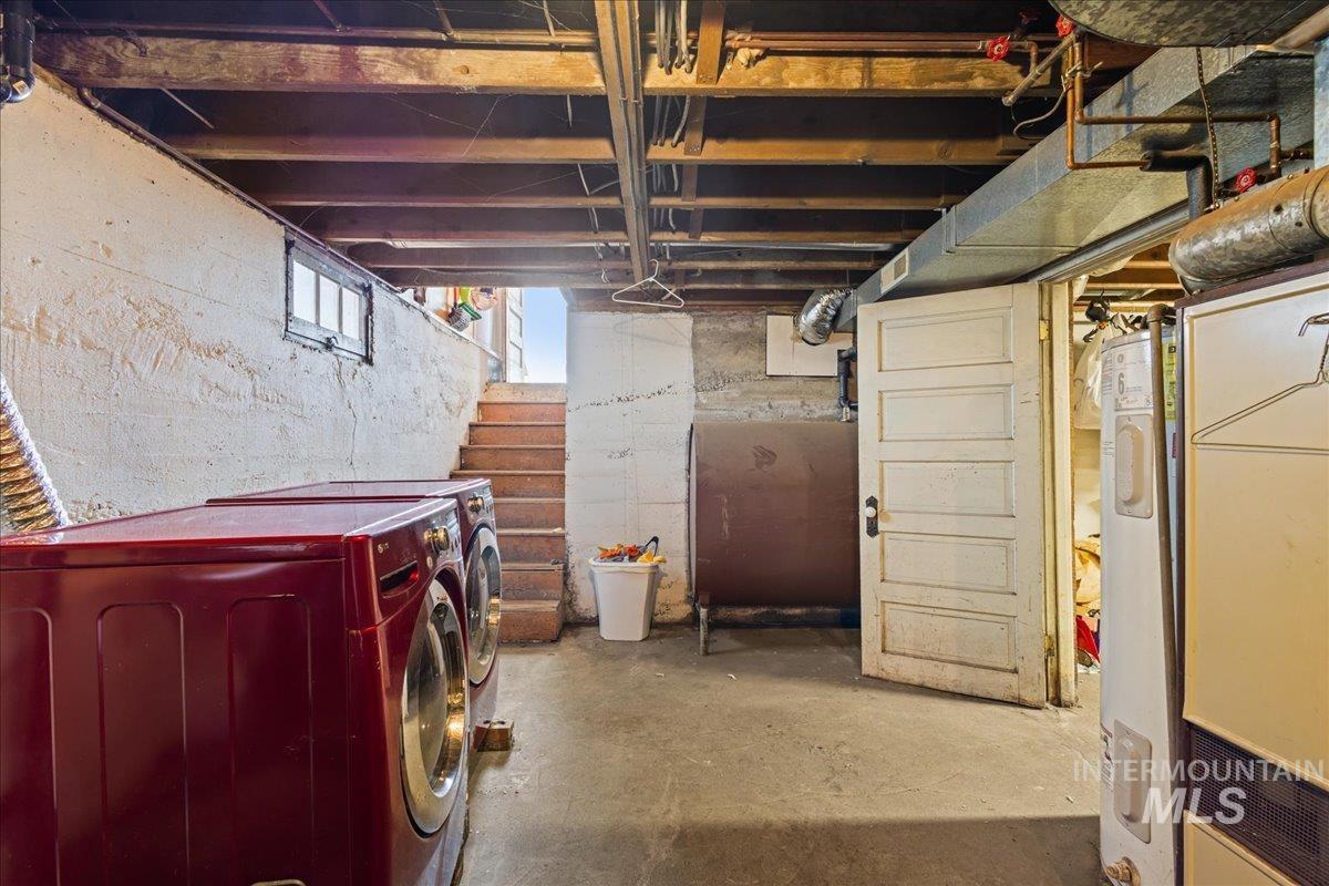 19454 Idaho Road Worley, ID 83876 - Photo 28 of 39 Basement utility space featuring concrete flooring, exposed ceiling joists, and a window for natural light