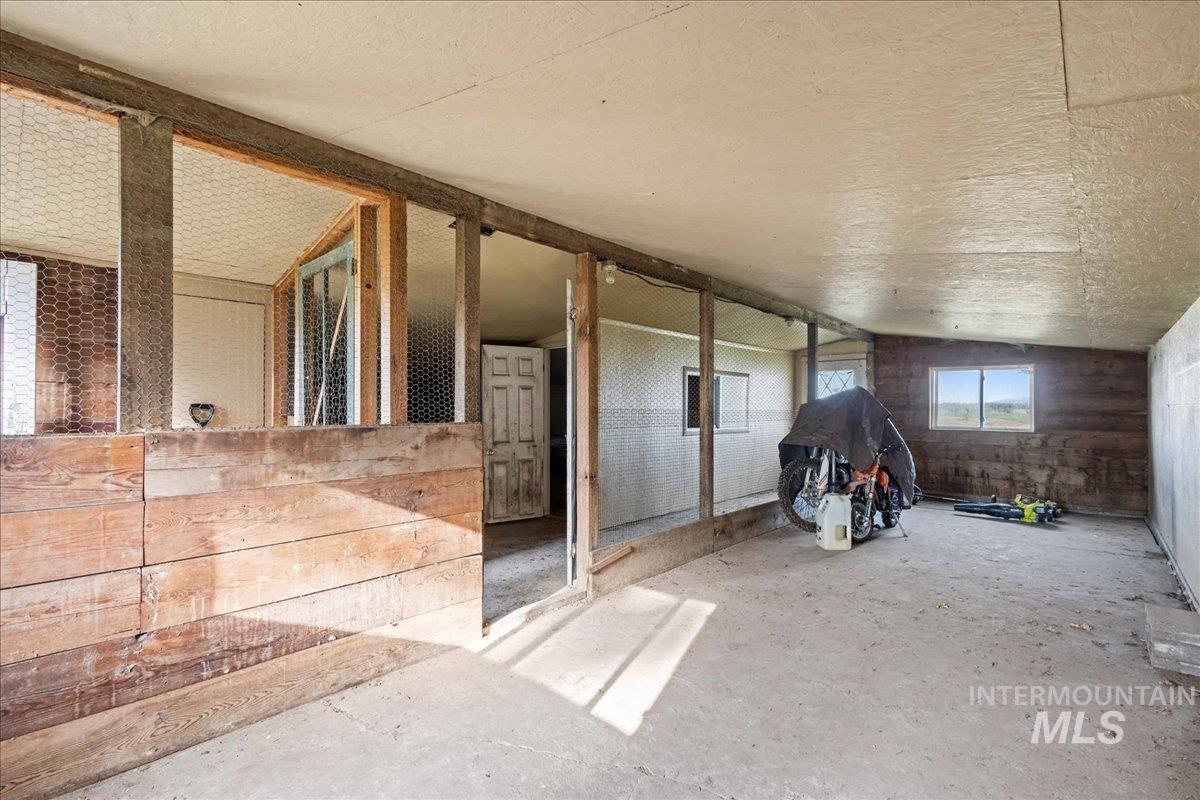 19454 Idaho Road Worley, ID 83876 - Photo 31 of 39 Concrete flooring with rustic wood plank walls and a ceiling-mounted light fixture