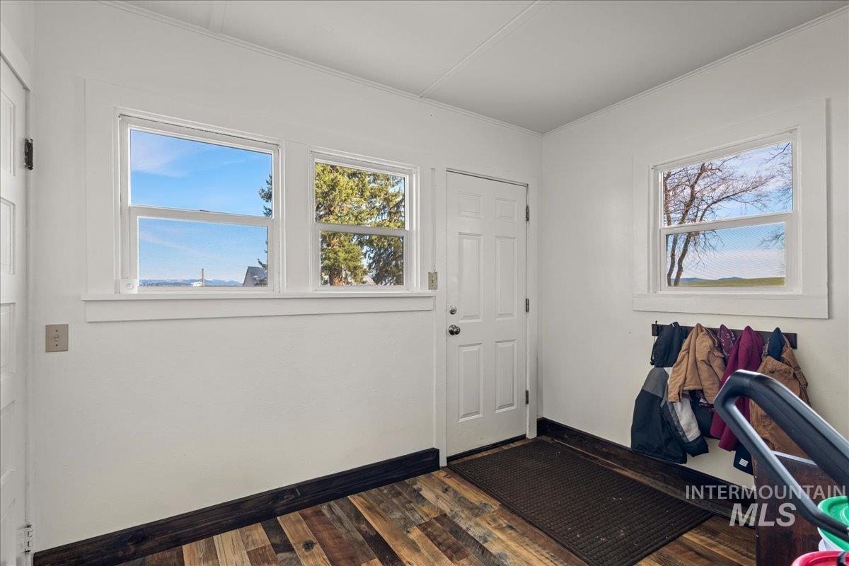 19454 Idaho Road Worley, ID 83876 - Photo 7 of 39 Entryway featuring wood-finish flooring, white paneled walls, and multiple windows