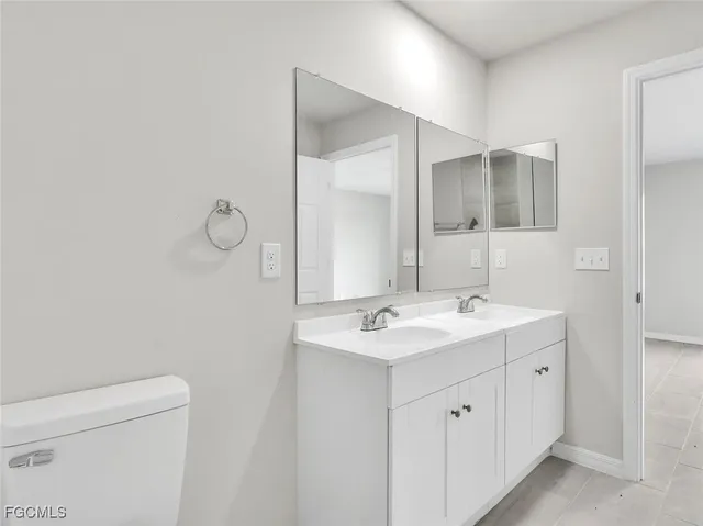a bathroom with a double vanity sink and mirror