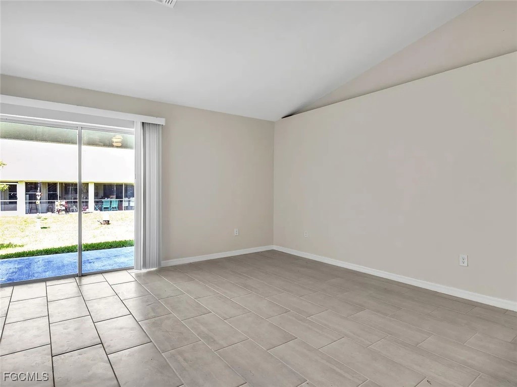 4622 Southwest 8th Court Cape Coral, FL 33914 - Photo 6 of 8 wooden floor in an empty room with a window