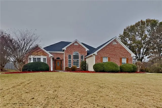 a front view of a house with a yard