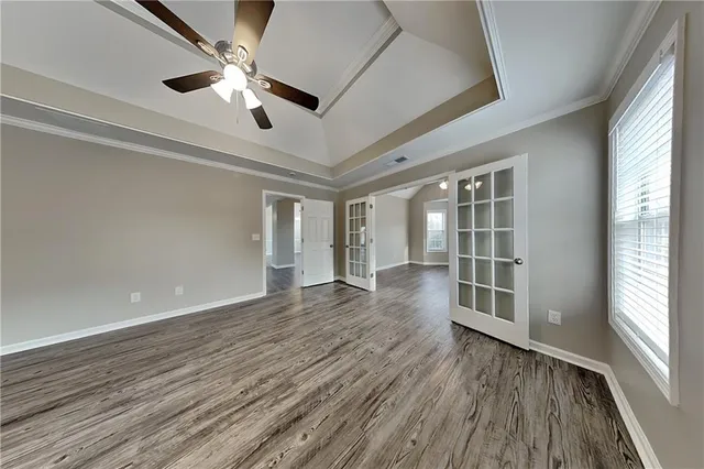 wooden floor in an empty room with a window