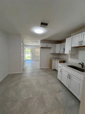 a view of a kitchen with a sink and cabinets