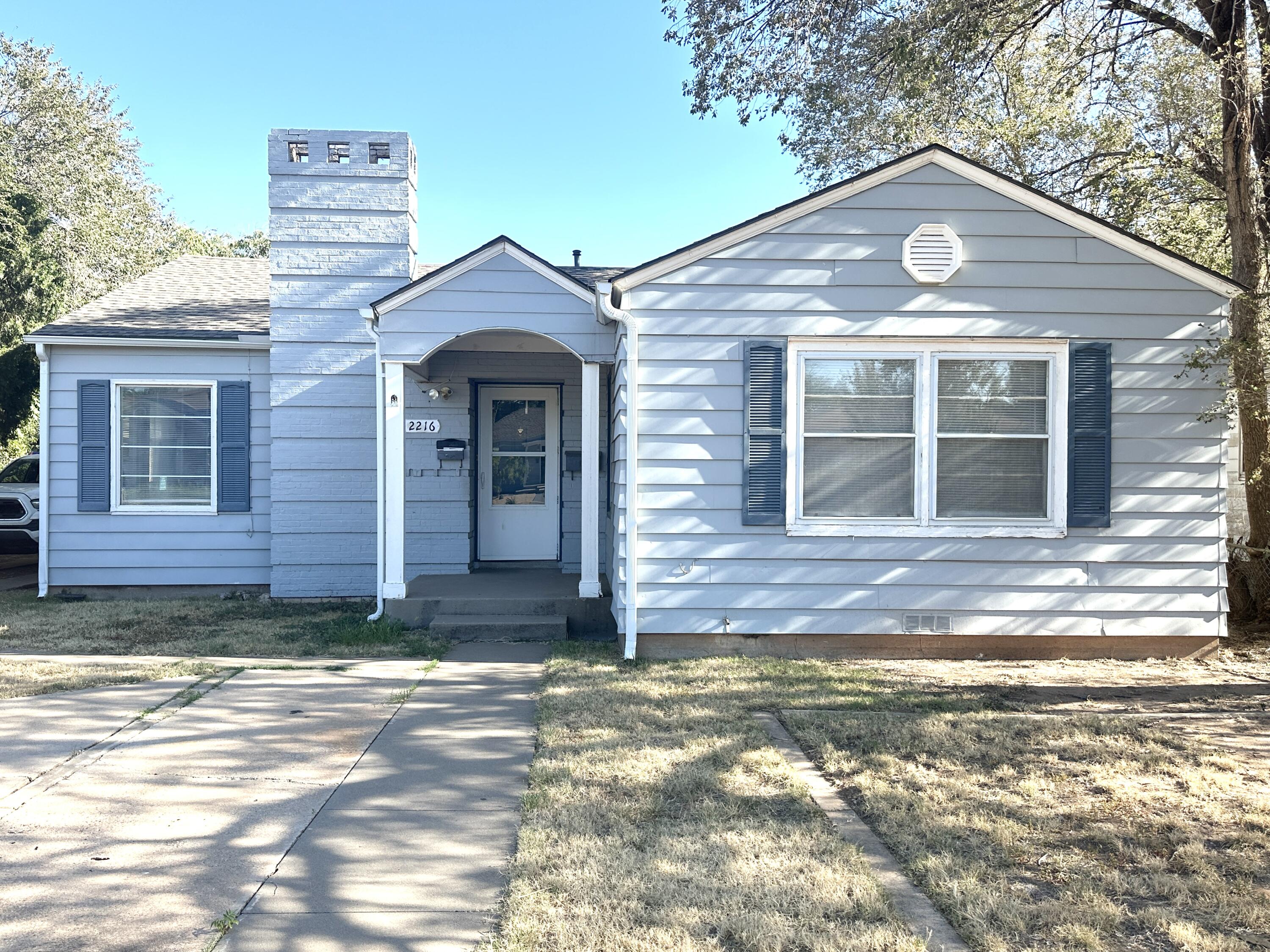 2216 30th Street, Unit FRONT Lubbock, TX 79411 - Photo 1 of 11 a front view of a house with a yard