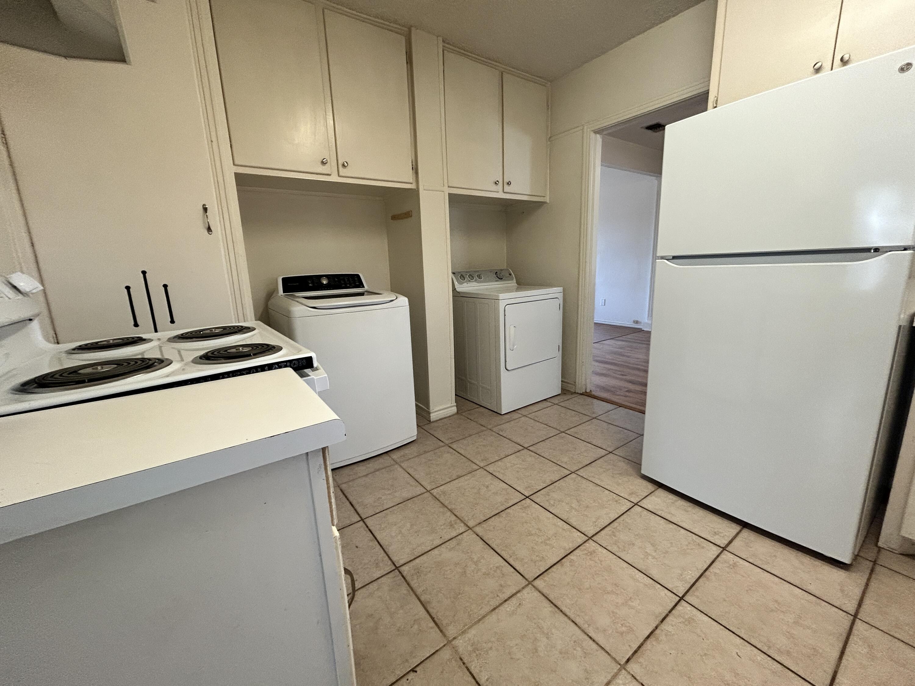 2216 30th Street, Unit FRONT Lubbock, TX 79411 - Photo 4 of 11 a kitchen with a refrigerator sink stove and cabinets