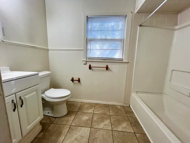 a bathroom with a toilet and a bathtub