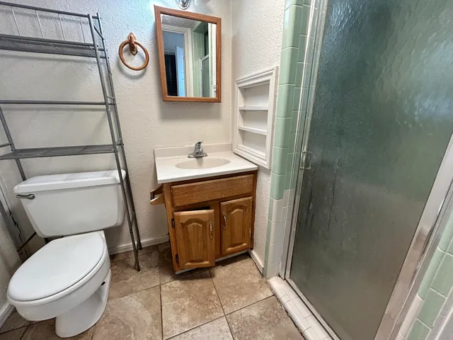 a bathroom with a toilet a sink and mirror