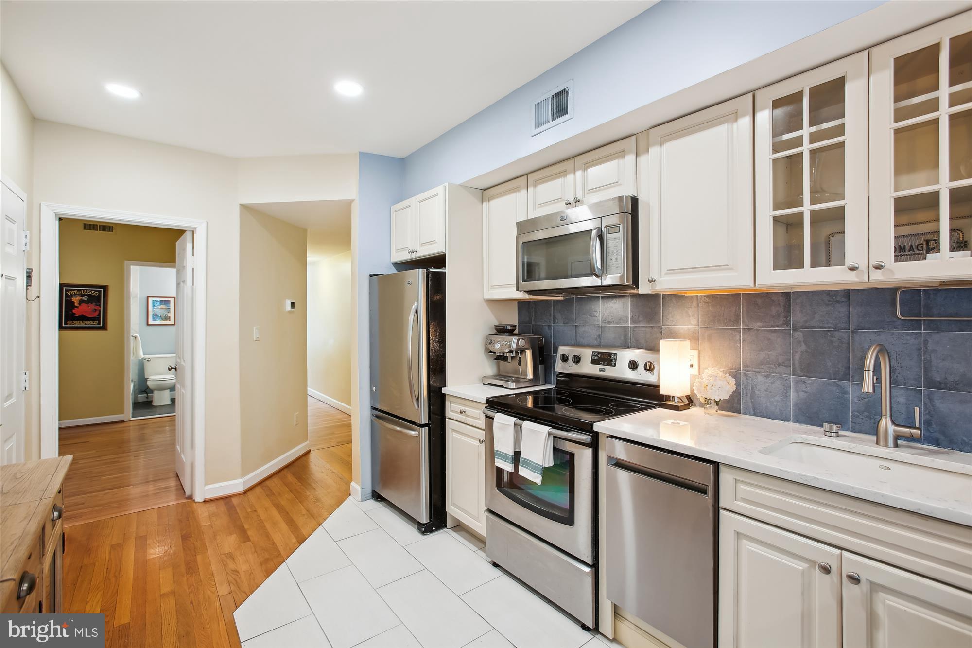 1725 Willard Street Northwest, Unit 3 Washington, DC 20009 - Photo 11 of 32 a kitchen with stainless steel appliances granite countertop a stove and a refrigerator