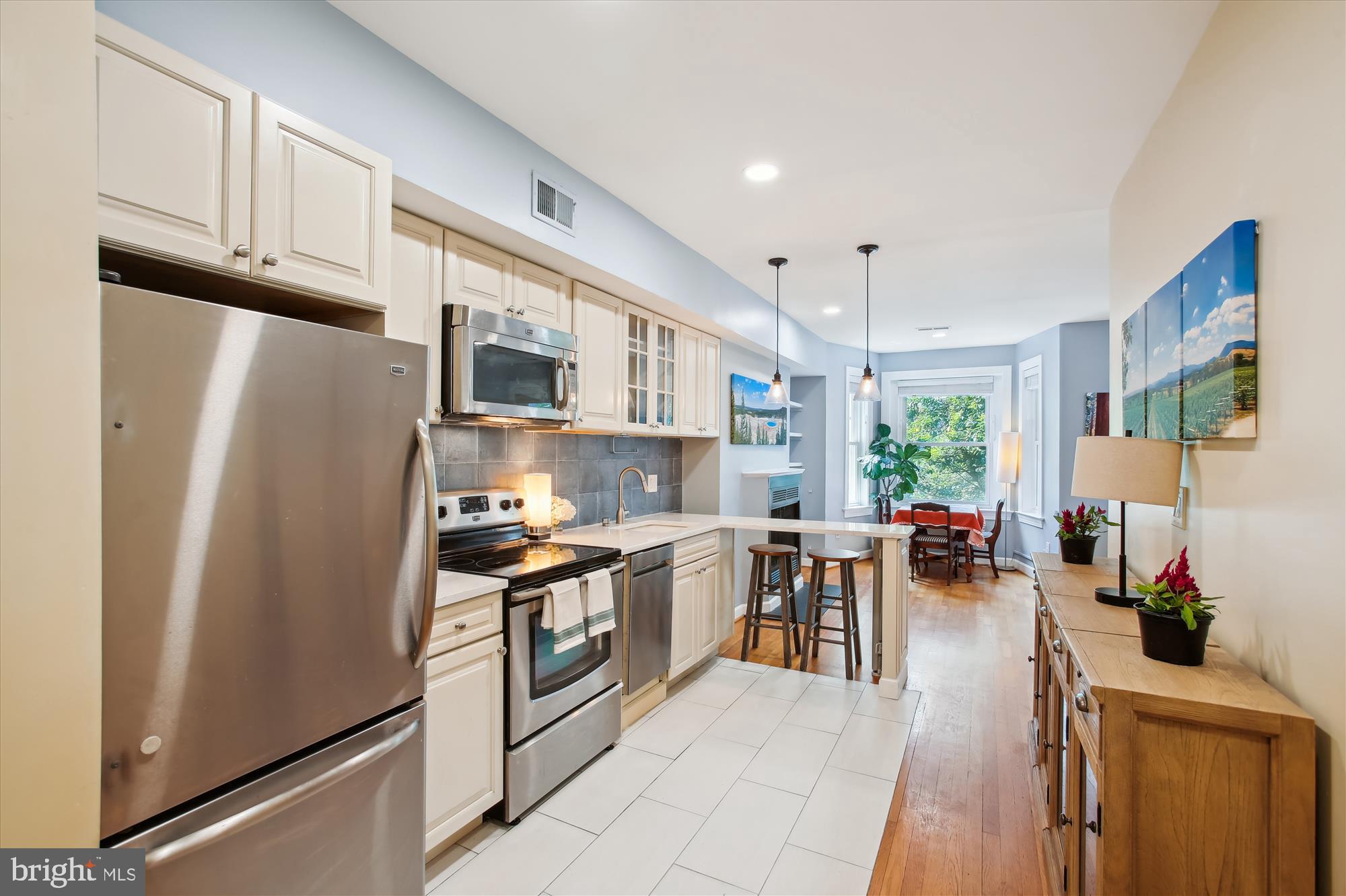 1725 Willard Street Northwest, Unit 3 Washington, DC 20009 - Photo 12 of 32 a kitchen with stainless steel appliances granite countertop a refrigerator stove microwave and sink