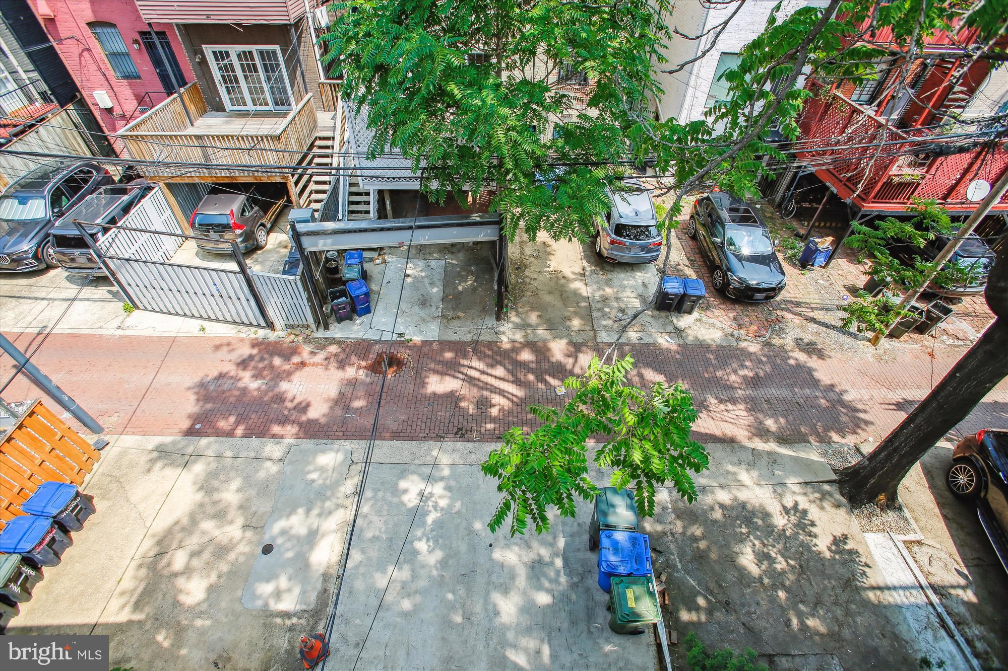 1725 Willard Street Northwest, Unit 3 Washington, DC 20009 - Photo 27 of 32 a view of a patio with table and chairs potted plants and large tree
