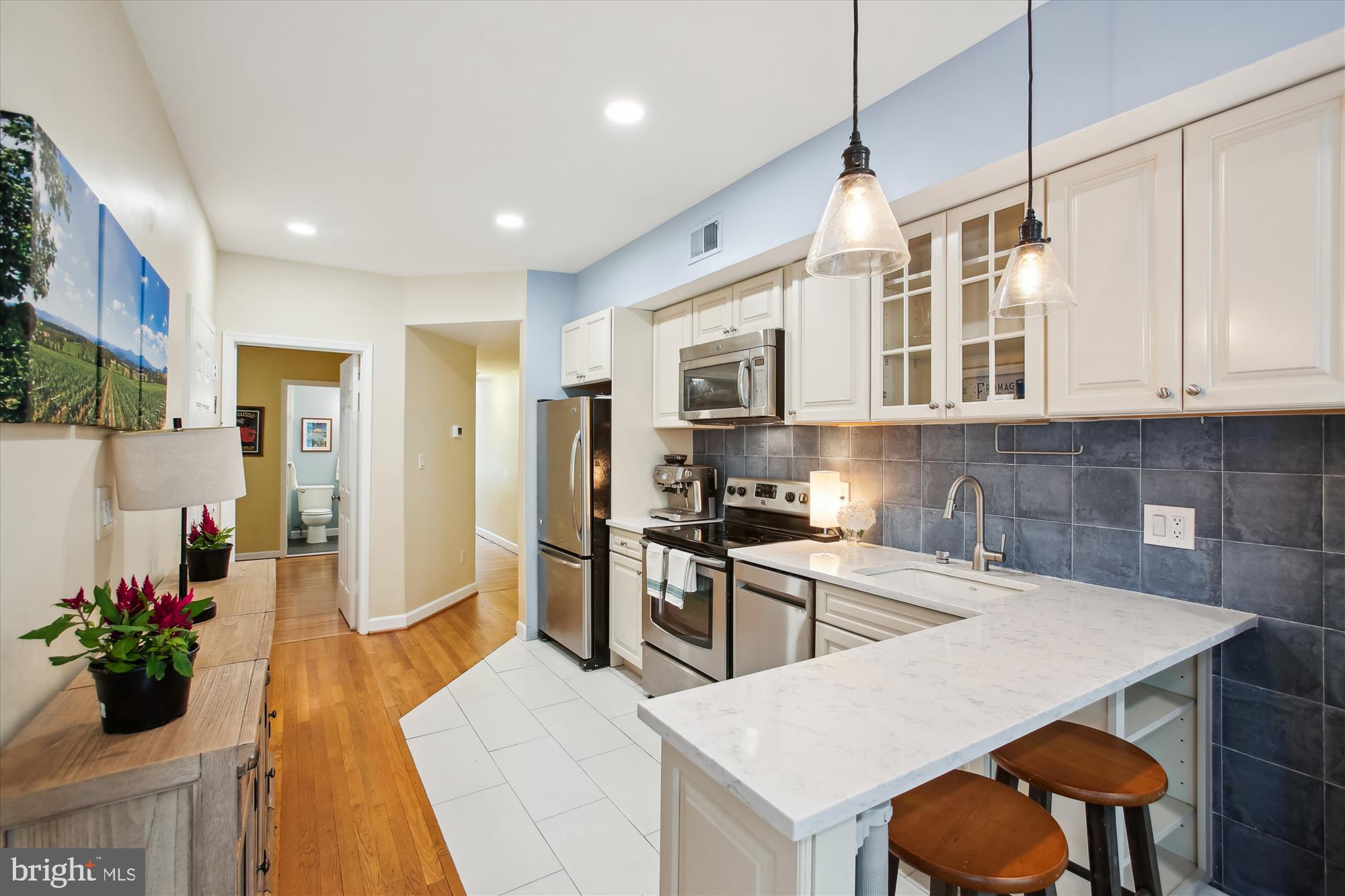 1725 Willard Street Northwest, Unit 3 Washington, DC 20009 - Photo 9 of 32 a kitchen with stainless steel appliances granite countertop a stove a sink a refrigerator and a microwave