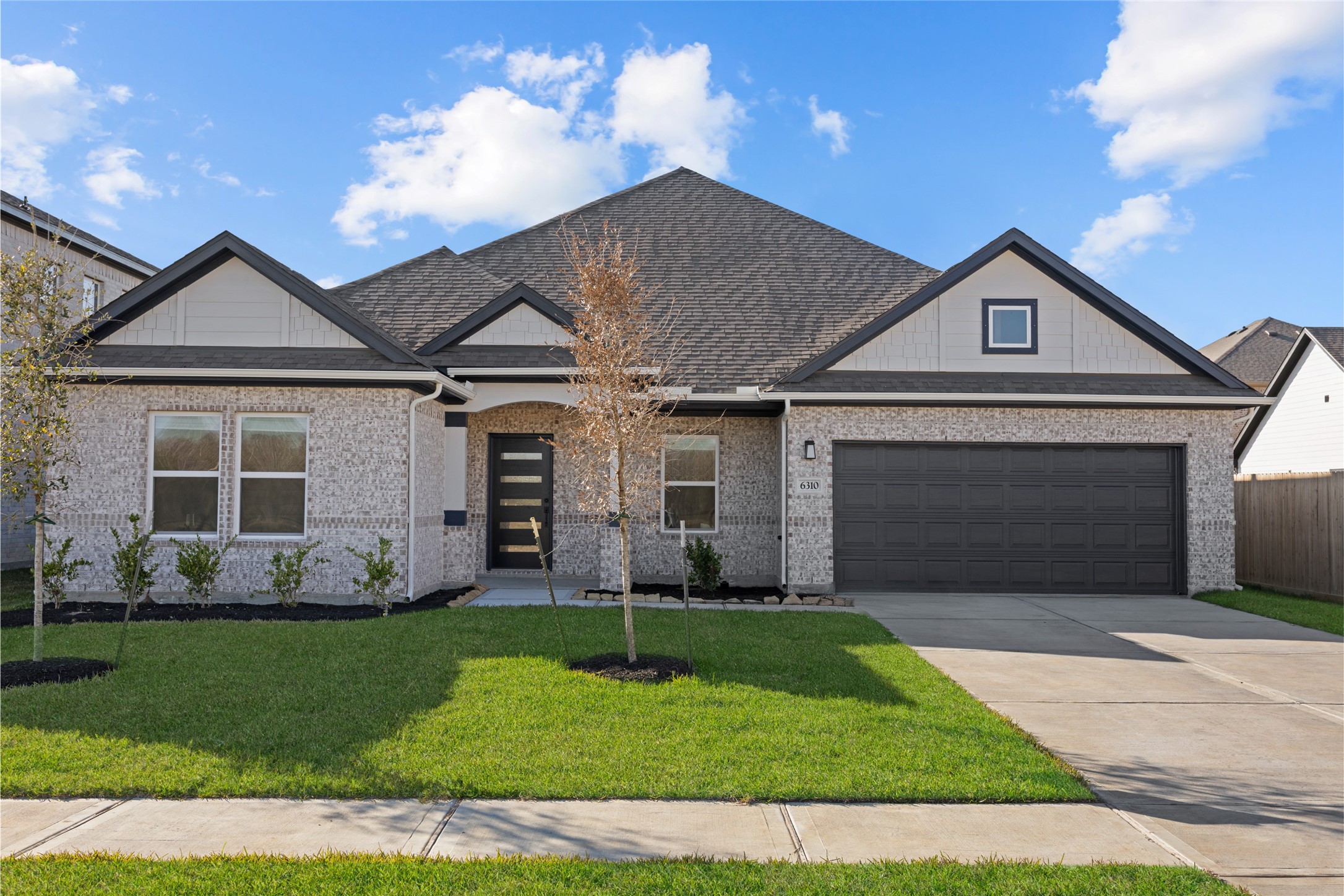 3222 Emerald Hills Drive Angleton, TX 77515 - Photo 1 of 31 a front view of a house with a yard and garage