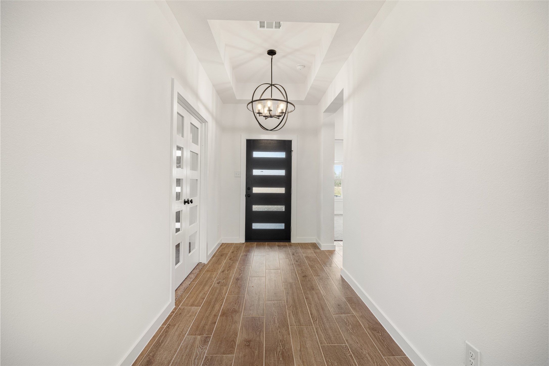3222 Emerald Hills Drive Angleton, TX 77515 - Photo 11 of 31 a view of a room with wooden floor and white walls