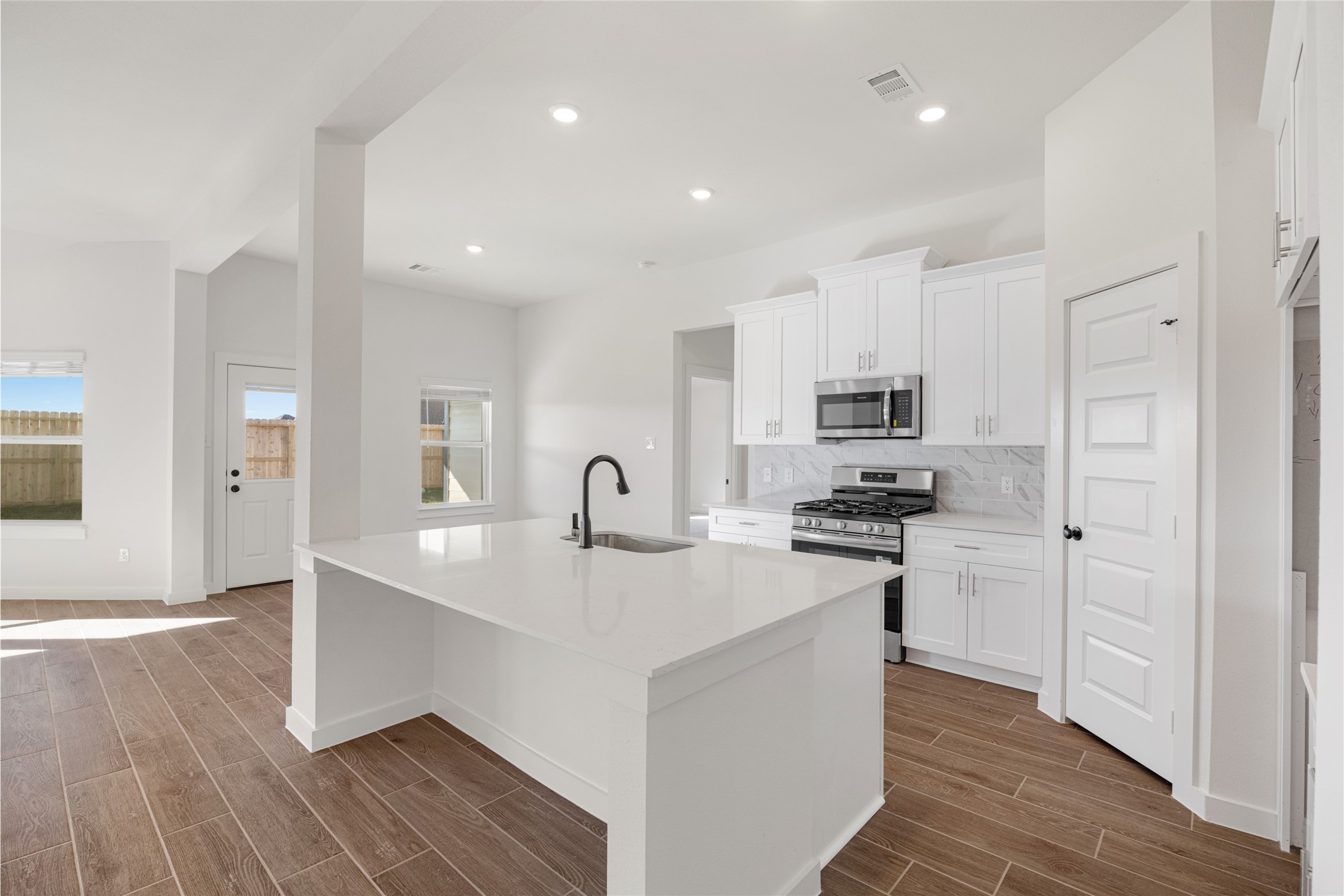 3222 Emerald Hills Drive Angleton, TX 77515 - Photo 16 of 31 a kitchen with stainless steel appliances granite countertop a sink stove and refrigerator