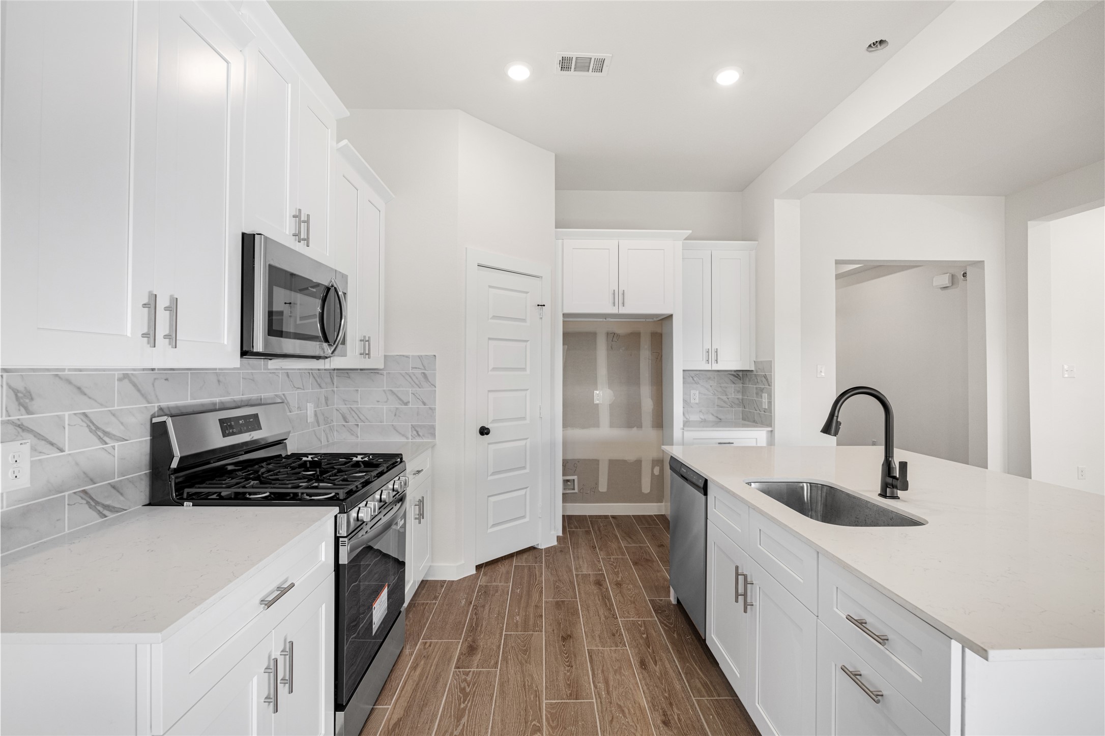3222 Emerald Hills Drive Angleton, TX 77515 - Photo 3 of 31 a kitchen with kitchen island stainless steel appliances a sink stove and refrigerator