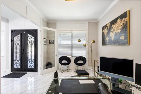 a view of a hallway with furniture and wooden floor