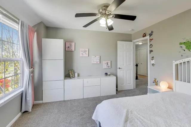 a bedroom with a large bed and a chandelier