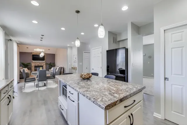 a kitchen with sink stove and refrigerator