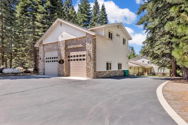 a view of a white house with a street