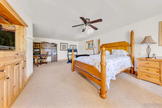a bed room with furniture and a flat screen tv