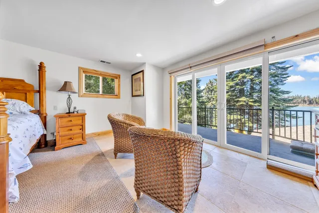 a living room with furniture and large windows