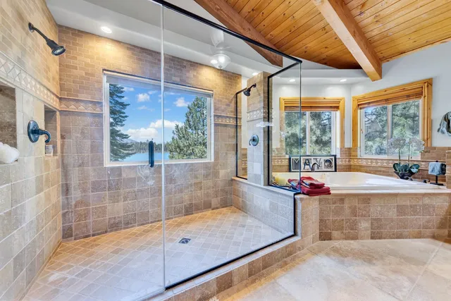 a view of a bathroom with a tub and shower
