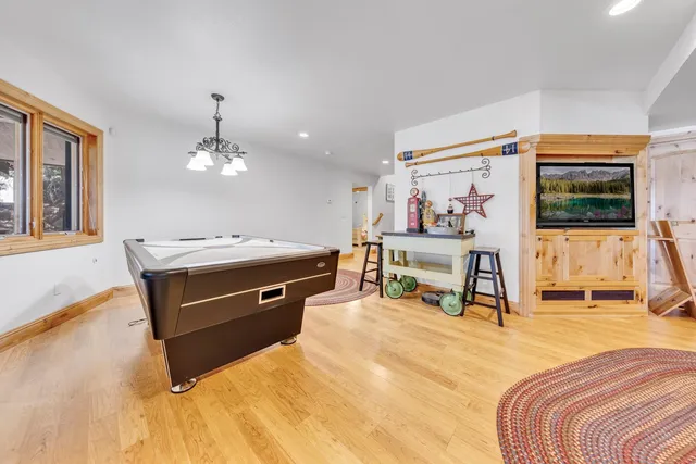 a spacious bedroom with a bed and a chandelier