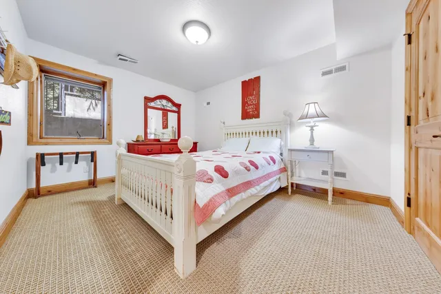 a bedroom with a bed and a table