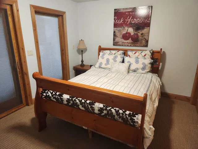 a bed sitting in a bedroom next to a window