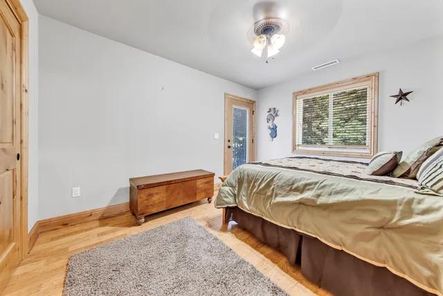 a bed sitting in a bedroom next to a window