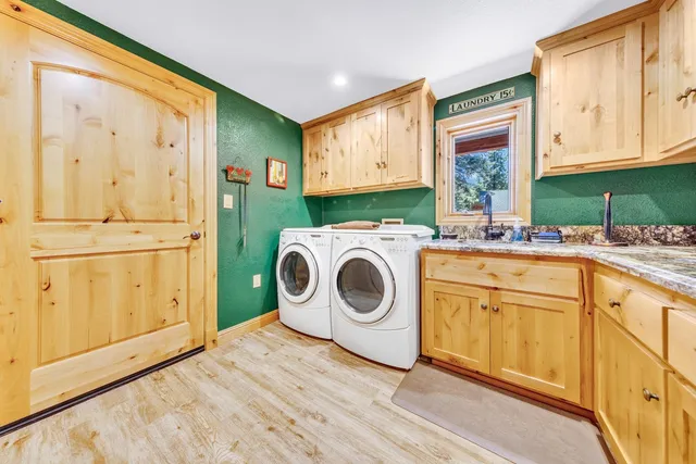 a utility room with sink dryer and washer