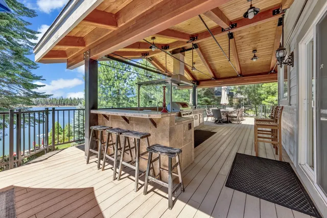 a view of a patio with lawn chairs and wooden floor