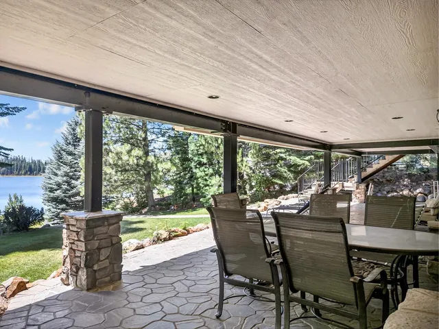 a dining room with furniture and a floor to ceiling window