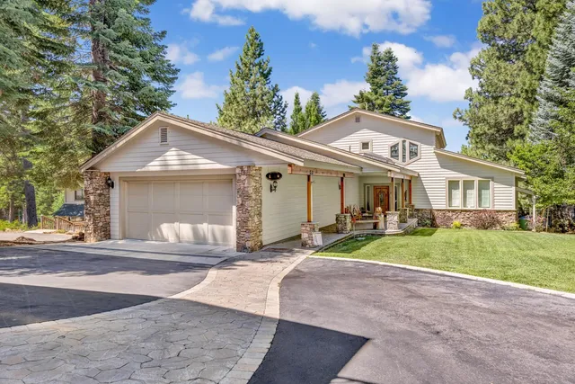 a front view of a house with a yard and porch