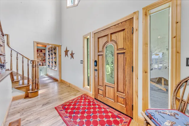 a view of a hallway with wooden floor and windows