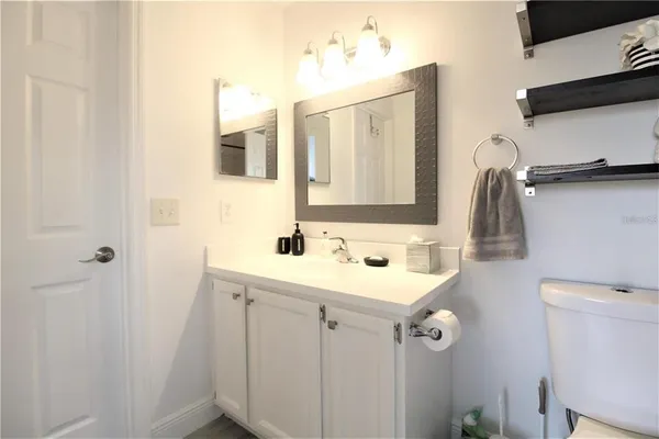 a bathroom with a toilet a sink and a mirror