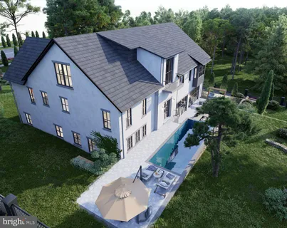 a aerial view of a house next to a big yard and large trees