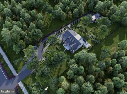 an aerial view of a house a yard and outdoor seating