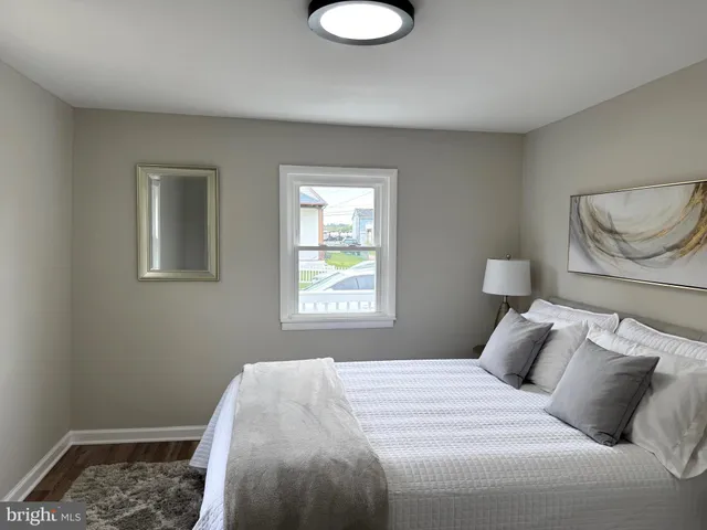 a bedroom with a bed and window