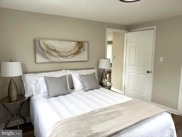 a bedroom with a bed and a painting on the wall