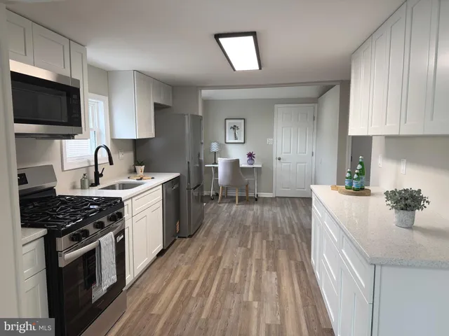 a kitchen with a sink stove and cabinets