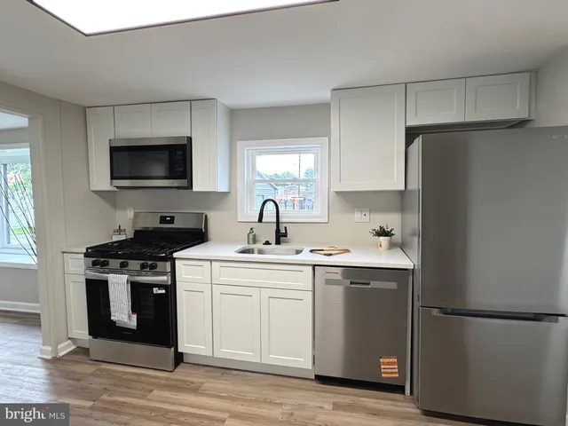 a kitchen with a sink a stove and refrigerator