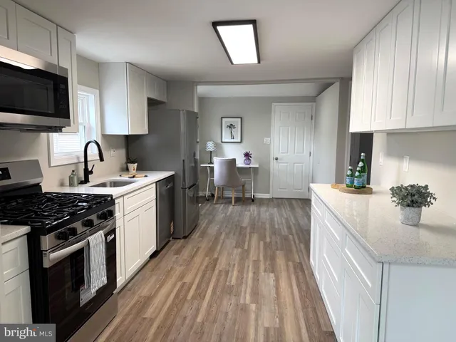 a kitchen with a sink stove and cabinets