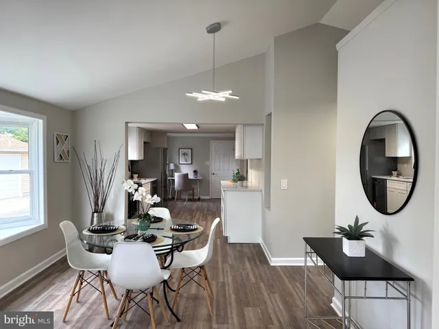a dining room with furniture and wooden floor