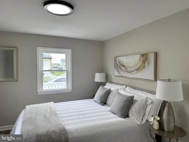 a bedroom with a bed and a lamp